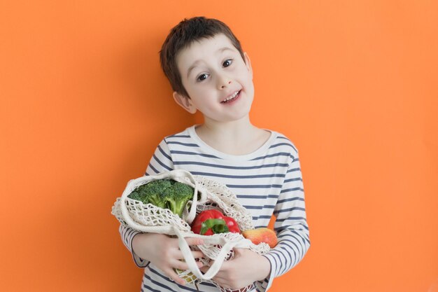 Photo child with eco bag with vegetables