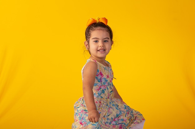 Child with facial expressions in a studio photo over colored background.