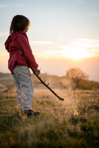 Child with fire in nature