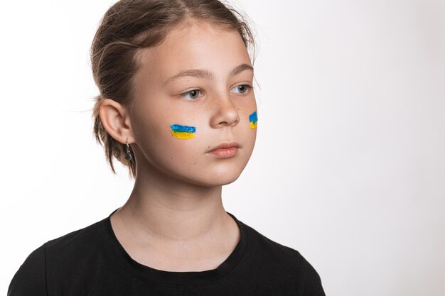 A child with the flag of Ukraine on his face The concept of war