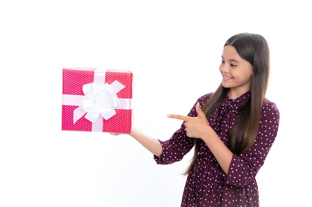 Child with gift present box on isolated studio background Gifting for kids birthday Portrait of happy smiling teenage girl