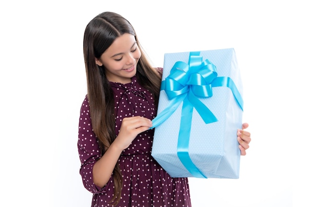 Child with gift present box on isolated white background Presents for birthday Valentines day New Year or Christmas Portrait of happy smiling teenage child girl