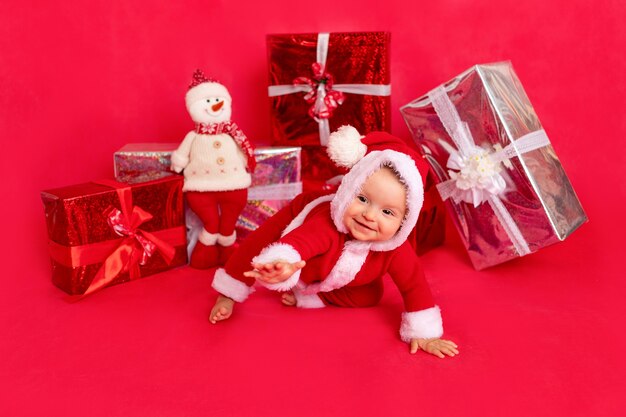 Child with gifts in a Santa suit