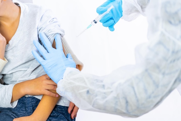 Child with his mother before the vaccine injection. Vaccination of children. Immunization in the coronavirus pandemic, covid-19