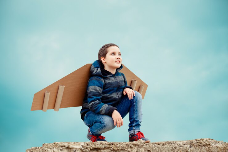 Child with paper airplane wings
