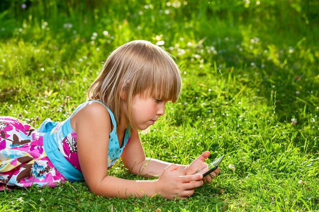 Photo child with a tablet computer outdoor