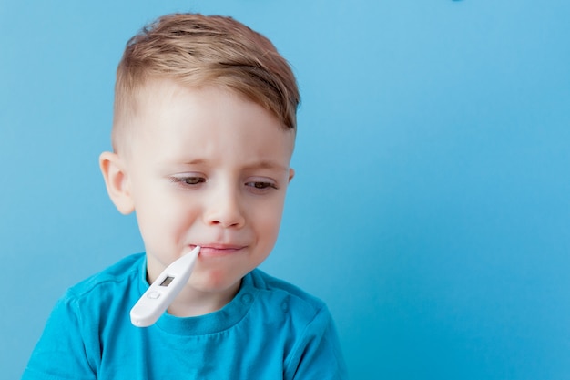 Child with a thermometer in his mouth