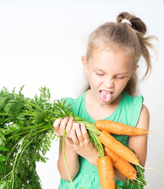 A child with a vegetable carrots