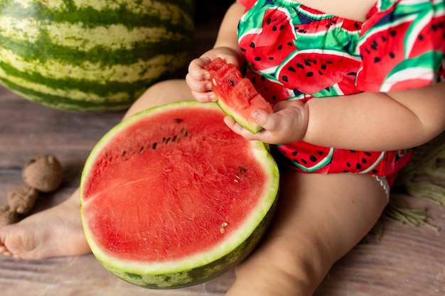 child with watermelon. little girl with blond hair eats watermelon. healthy fresh vitamins watermelo