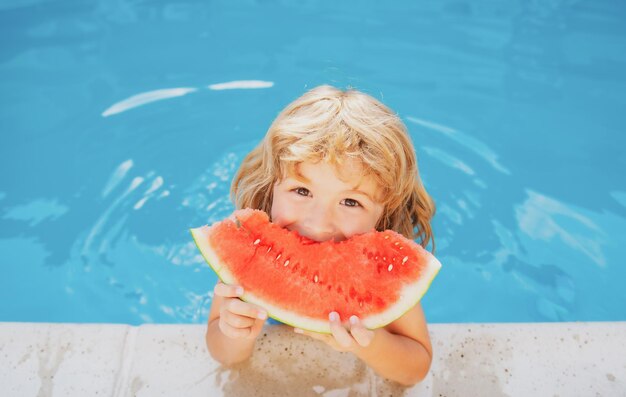 Child with watermelon in swimming pool kids eat summer fruit outdoors healthy children