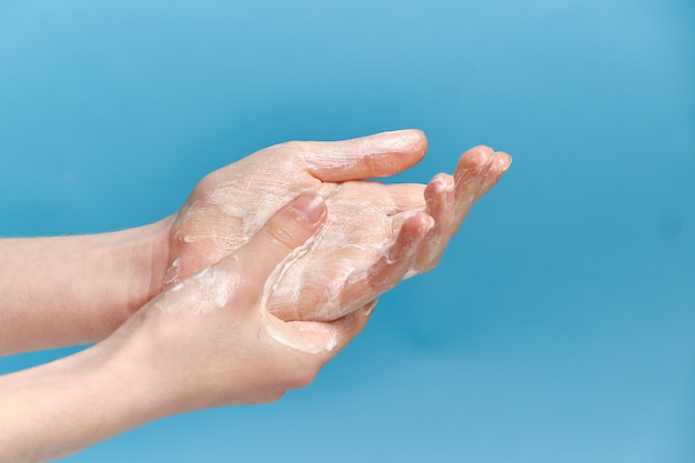 a child without a face washes his hands