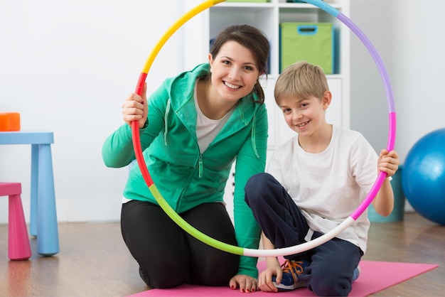 A child and a woman holding a hoop with a child on it