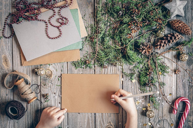 Child writes a letter to santa claus flat lay