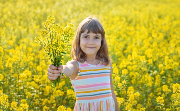 A child in a yellow field, mustard blooms