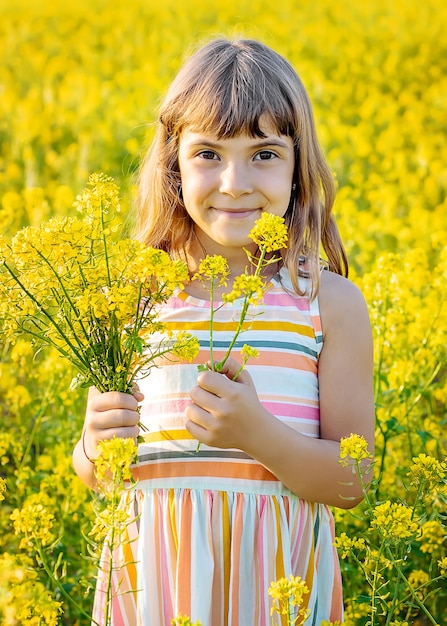 A child in a yellow field, mustard blooms