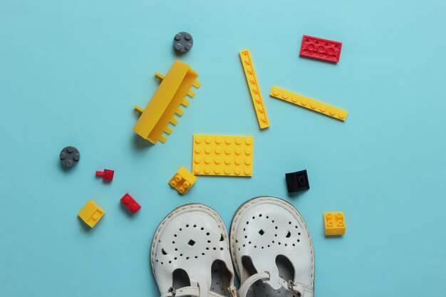 Childhood concept Childrens sandals toy bricks