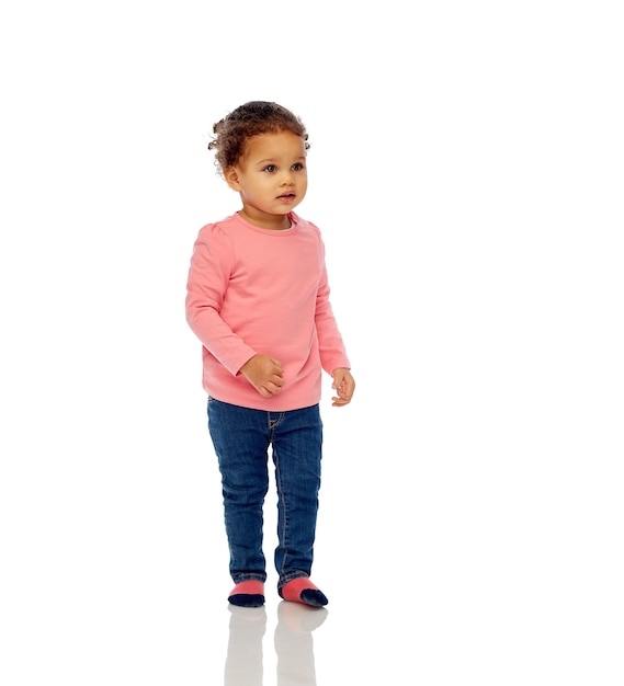 childhood, fashion, clothing and people concept - beautiful little african american baby girl walking