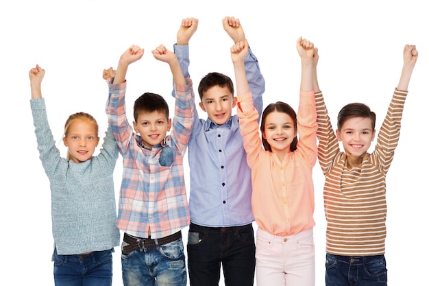 childhood, fashion, gesture and people concept - happy children friends raising fists and celebrating victory