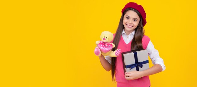 Childhood happiness boxing day kid in beret with toy smiling child has birthday kid girl with gift