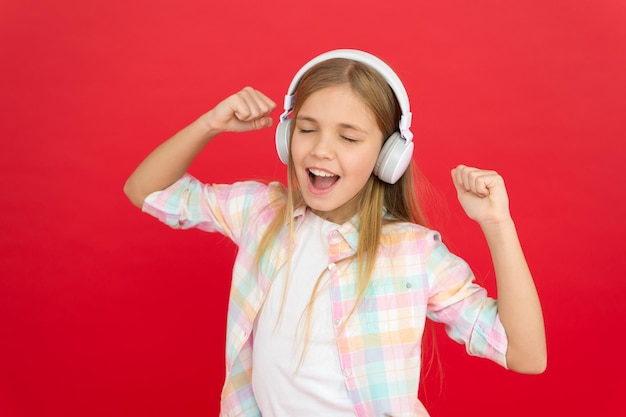 Childhood happiness Mp3 player small kid listen ebook education childrens day Audio technology small girl child in headphones Listen to music Beauty fashion Enjoying the rhythm of her life