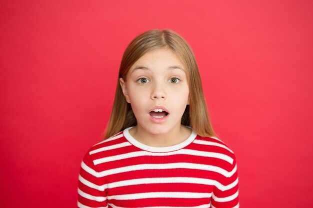 Childhood happiness. small girl child. School education. family and love. childrens day. Good parenting. Child care. surprised little girl on red background. Oops.