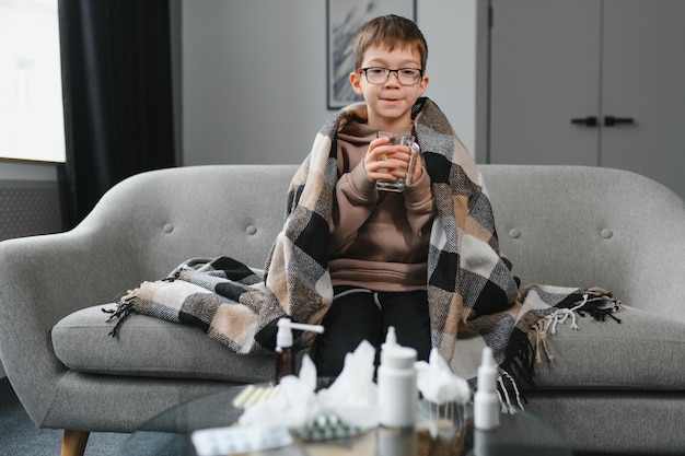 Childhood healthcare and medicine concept ill boy with flu at home