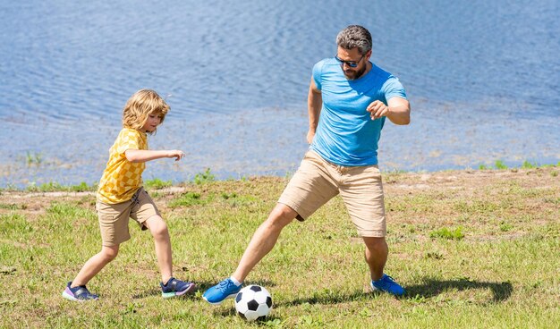 Childhood memories of son and his dad dad have fun with his son discovering fatherhood dad and son enjoying childhood adventures outdoor dad and son playing football during their childhood