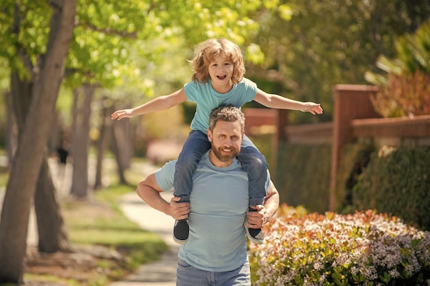 Childhood and parenthood parent relax with small child boy dad with kid on summer day