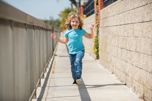 Childhood play Happy boy have fun running on promenade Outdoor play Summer activities