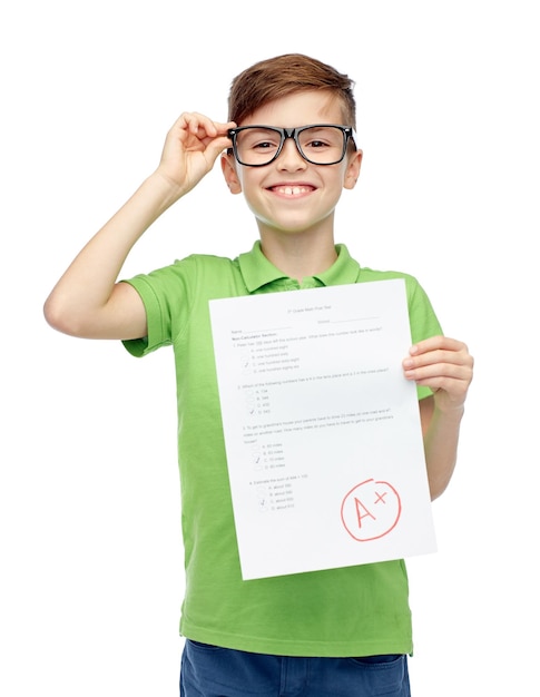 childhood, school, education and people concept - happy smiling boy in eyeglasses holding paper with test result