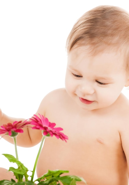 childhood and toys concept - cute little boy playing with flower