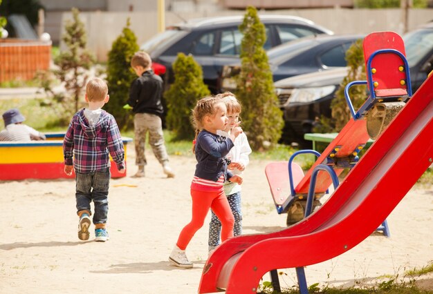 Children are playing at the playground outdoors