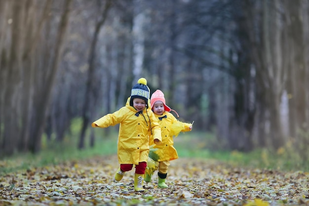 Children are walking in the autumn park