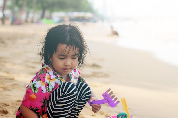 Children of asian playing toys at sea.