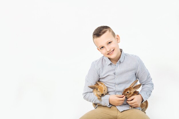 Children boy and girl happy with a beautiful fluffy little Bunny rabbits on the white background