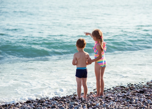 Children boy and girl on the ocean.