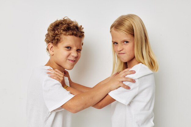 Children boy and girl posing on a white background Real emotions