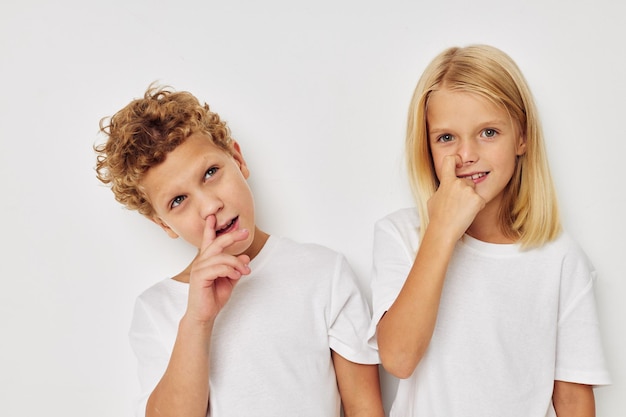 Children boy and girl posing on white background