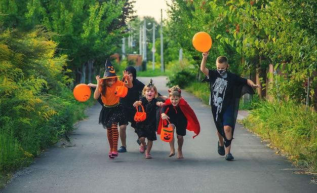 Children celebrate Halloween dressed up in costumes. Selective focus.