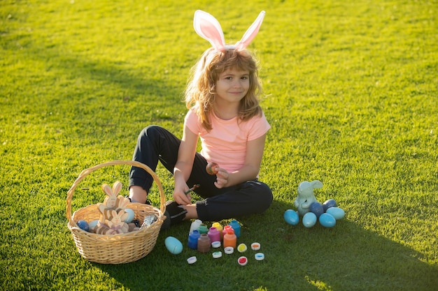 Children celebrating easter. Kid in rabbit costume with bunny ears outdoor. Cute little boy, easter bunny children spring outdoor.