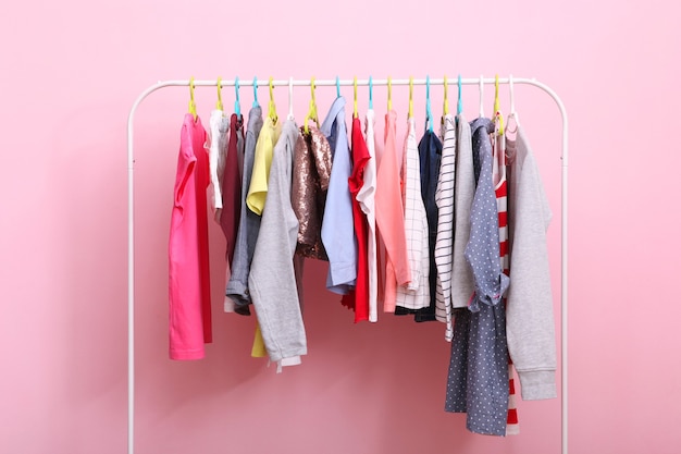 Children clothes on a hanger on a colored background