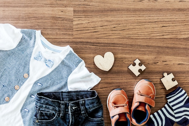 Children clothing on wooden background