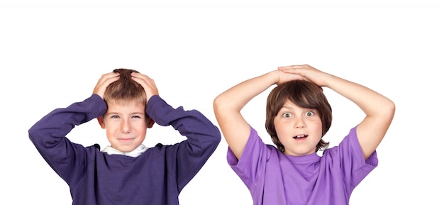 Children covering the ears and shocked by a loud sound