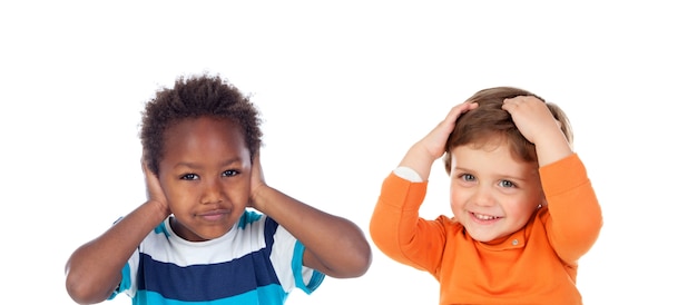 Children covering the ears and shocked by a loud sound