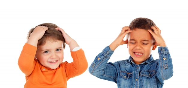 Children covering the ears and shocked by a loud sound