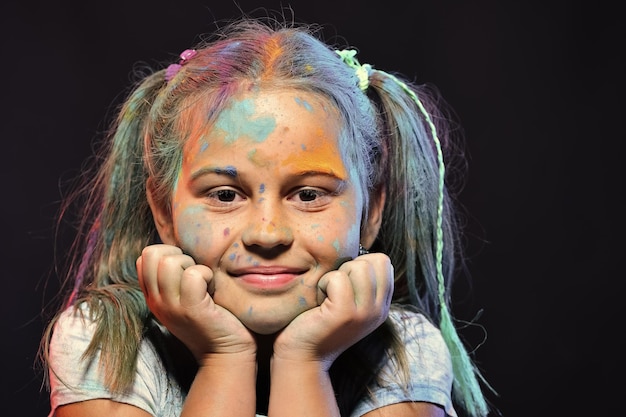 Children and creativity concept Schoolgirl has paint spots
