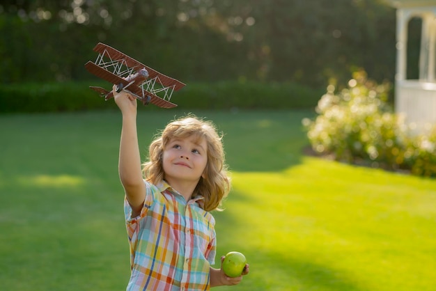 Children day Happy boy play in airplane outdoors Concept of dreams and travels Dreams of flying planes