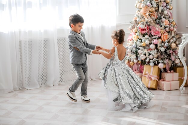 children decorate the Christmas tree