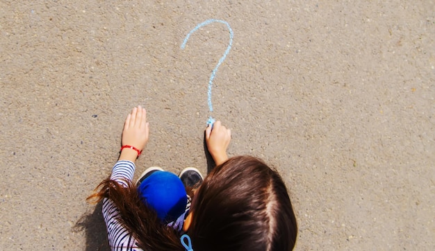 Children draw on the pavement with chalk Selective focus