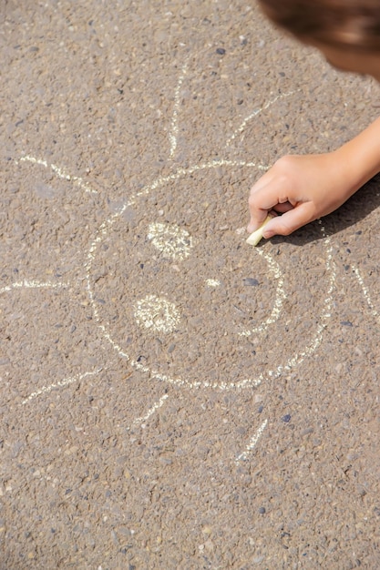 Children draw on the pavement with chalk Selective focus